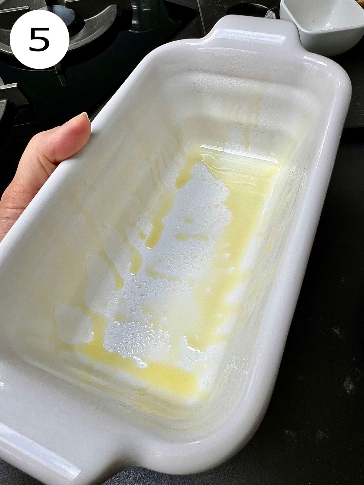 A white ceramic rectangular dish greased with olive oil.