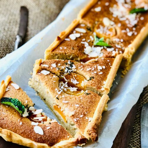 Close-up of a beautiful almond flour cake slices on parchment paper.