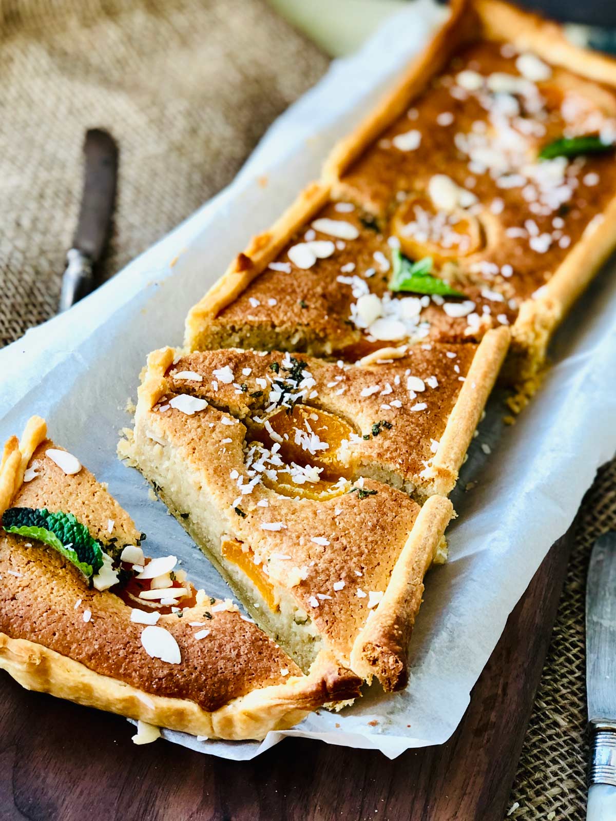 Close-up of a beautiful almond flour cake slices on parchment paper.