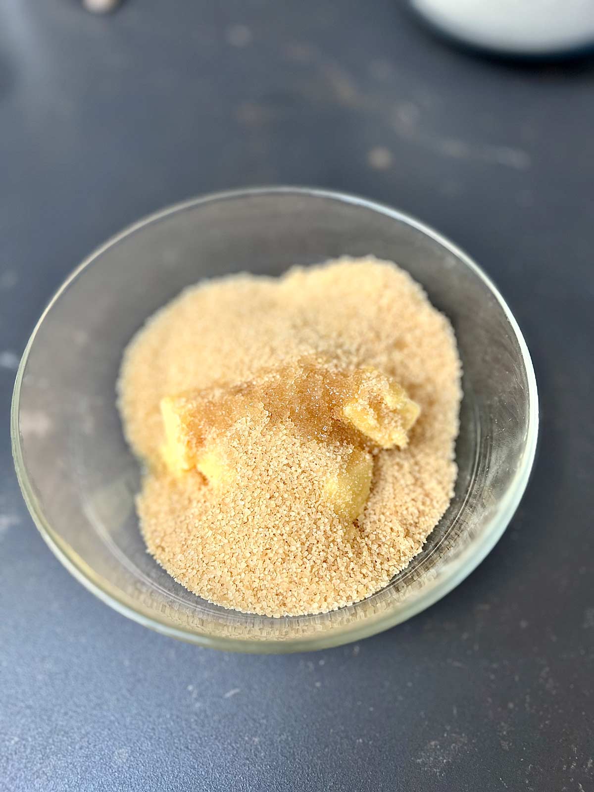 Cane sugar and butter in a glass bowl.