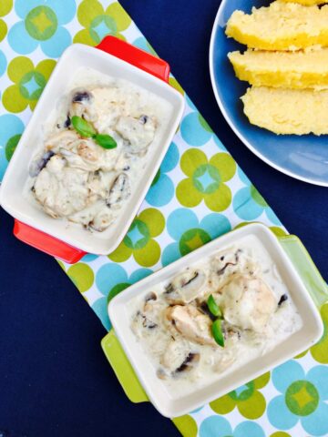 Creamy chicken and mushrooms with polenta, on a two rectangular serving dishes, birds view.