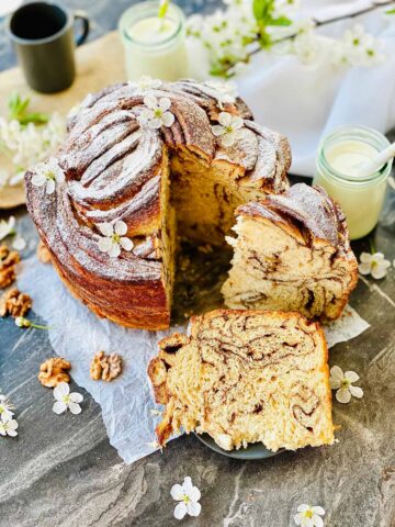 cruffin recipe with two glasses with milk with straws and scattered walnuts and cherry flowers
