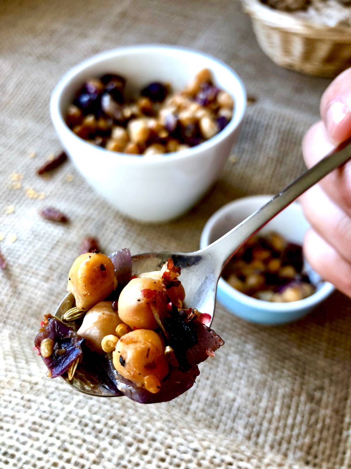 Closeup of a tablespoon full with sauteed chickpeas.