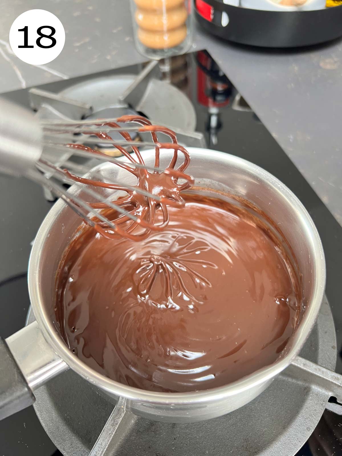 Ganache in a stainless steel pot being mixed.