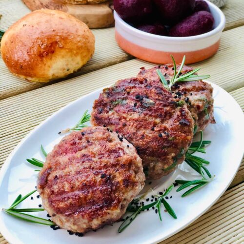 Homemade burgers with mint and cumin yogurt sauce