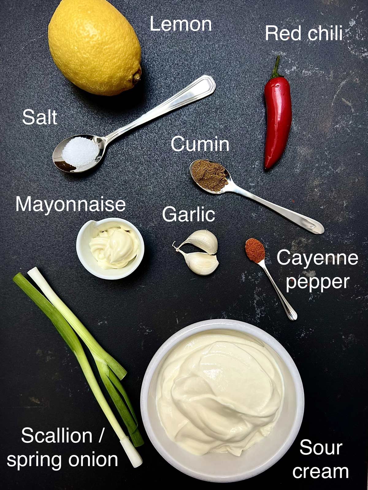 Ingredients needed to make sour cream sauce (lemon, red chilli salt, Cumin powder Cayenne pepper).