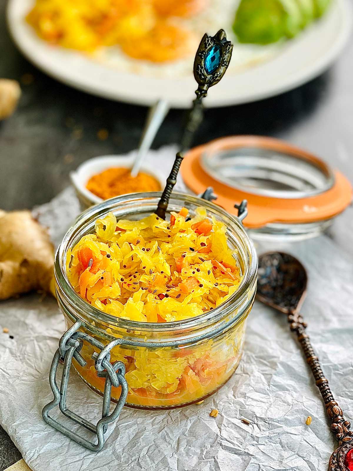 Raw Sauerkraut in a preserve jar and a spoon tucked in