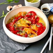 Roasted pepper salad in a plate with salad dressing.