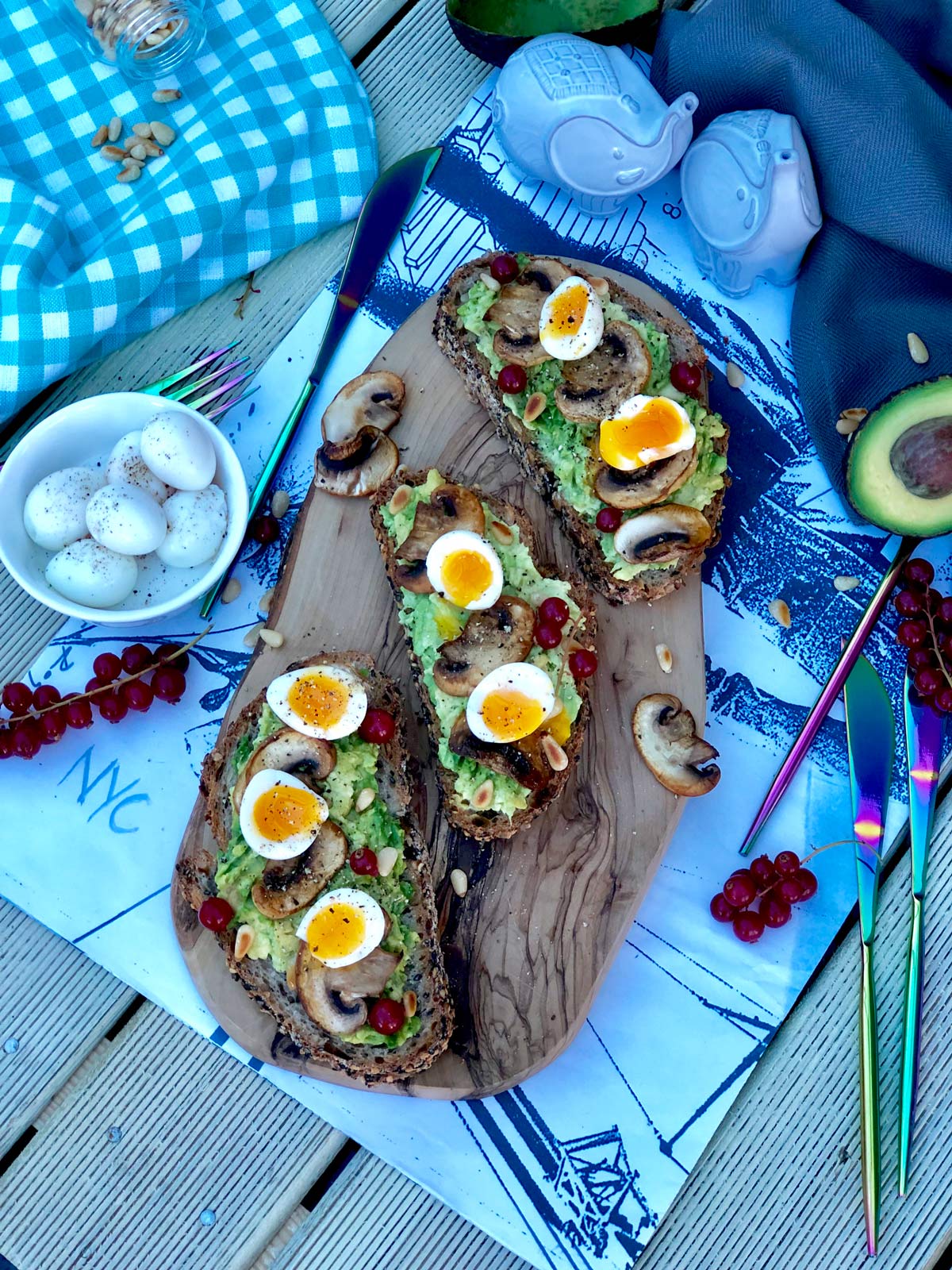 Soft boiled quail eggs, crushed avocado and red currants on seeded sourdough toast