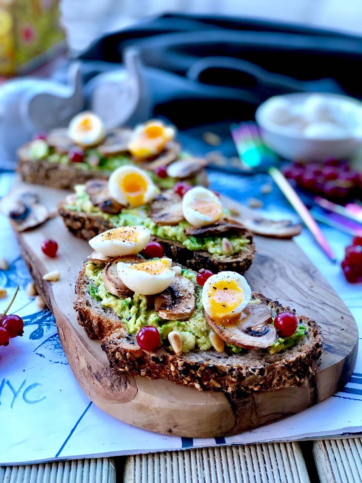Soft boiled quail eggs, crushed avocado and red currants on sourdough toast