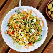 Vegetarian pesto courgette and carrot noodles with feta cheese and olives