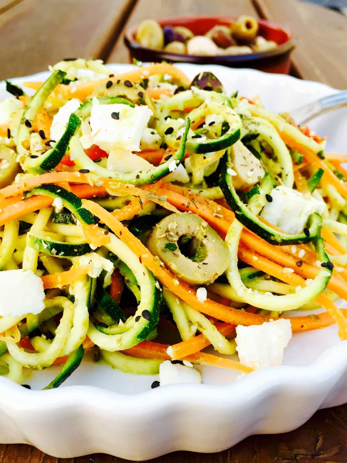 Vegetarian pesto, courgette and carrot noodles with feta cheese and olives