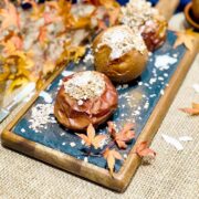 Baked apples with oatmeal on a blackboard