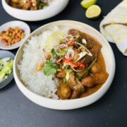 Beef Massman curry in a deep white ceramic plate.