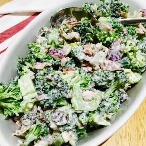 Broccoli salad, in a white oval bowl