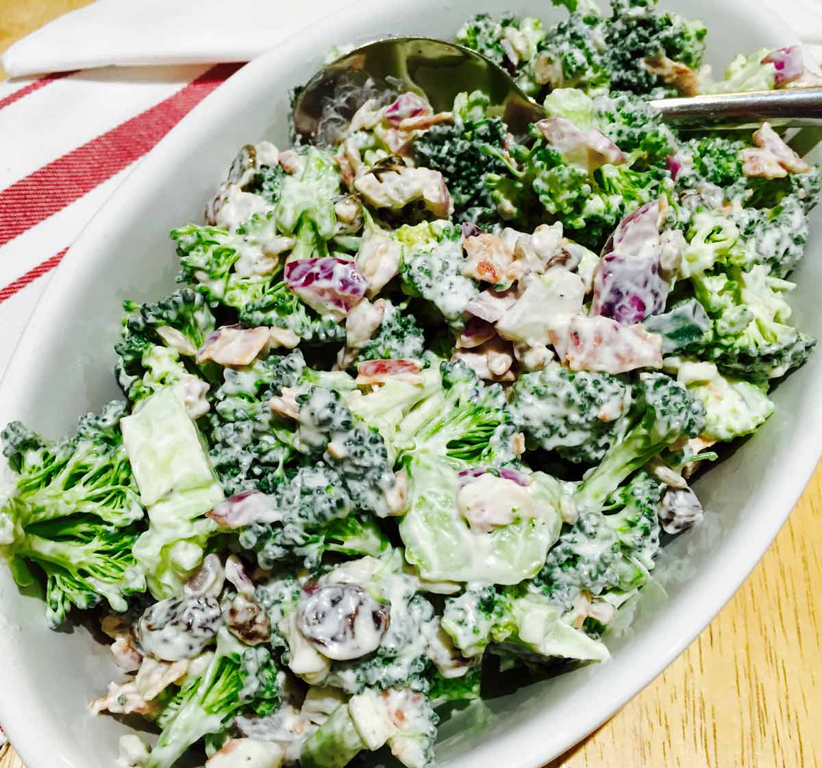 Broccoli salad, in a white oval bowl