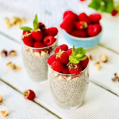 Chia pudding with nuts and raspberries in a glass