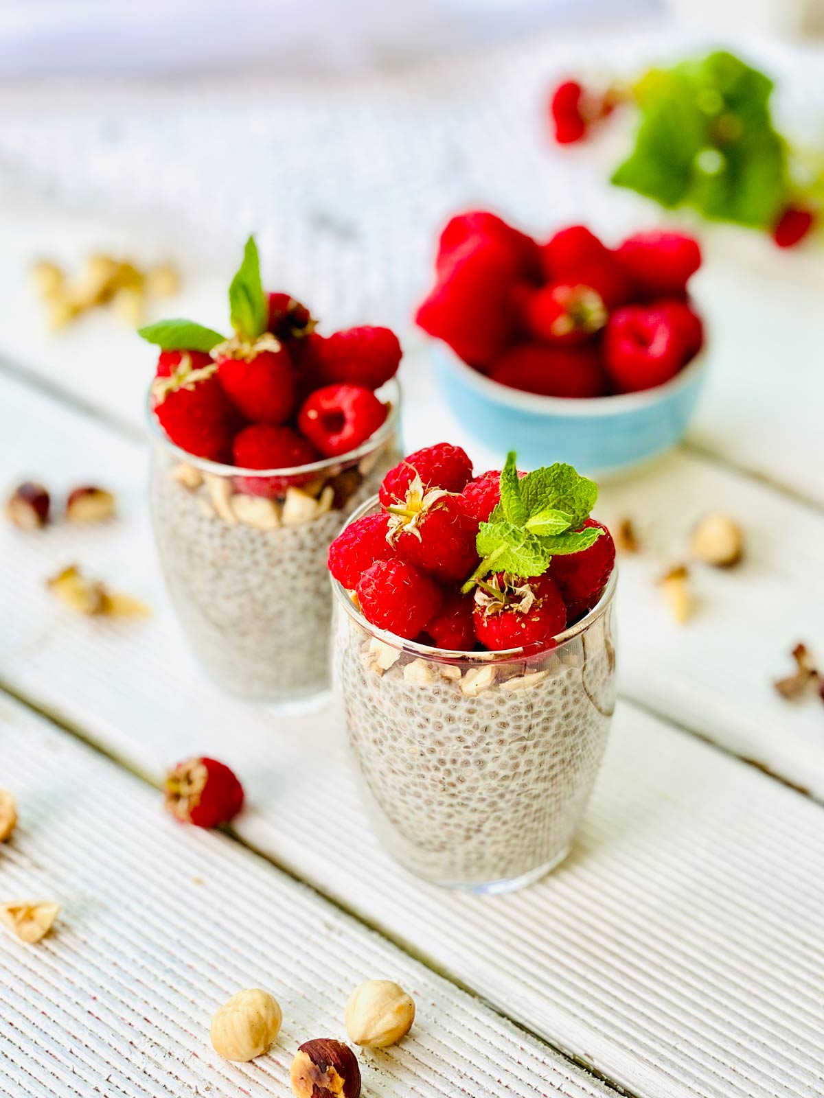 Chia pudding with nuts and raspberries in a glass