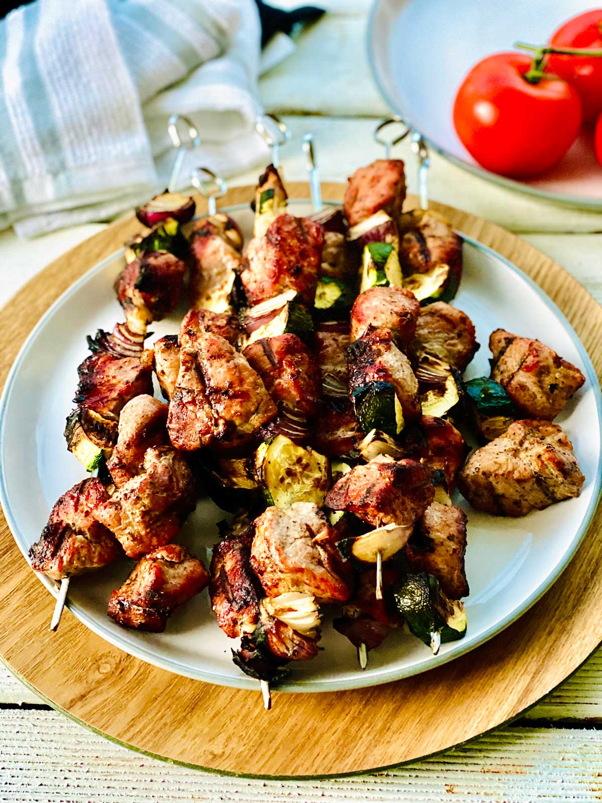 Chicken skewers in the oven on a white plate