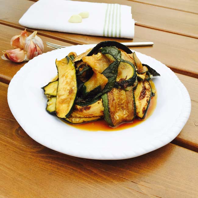 Some fried courgette slices on a white plate