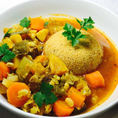 Couscous & lamb casserole, in a white bowl