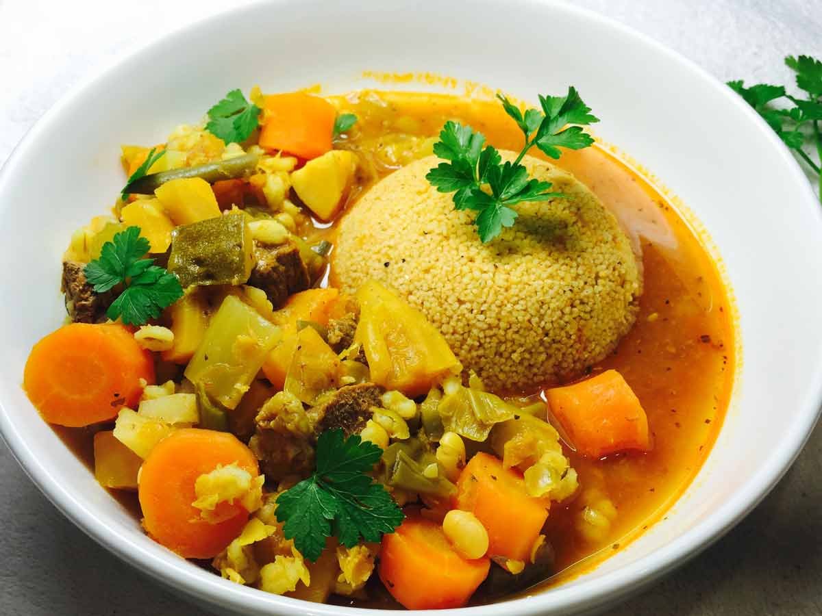 Couscous & lamb casserole, in a white bowl