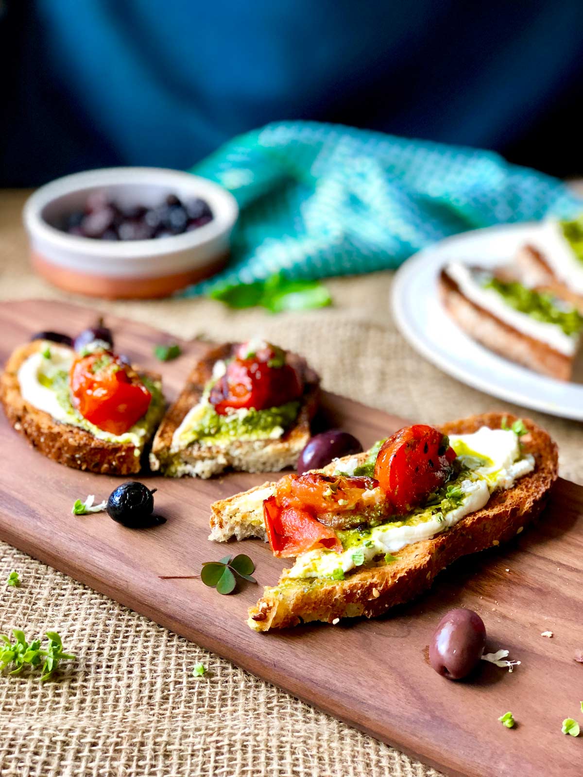 Cream cheese and pesto toast and basil flowers