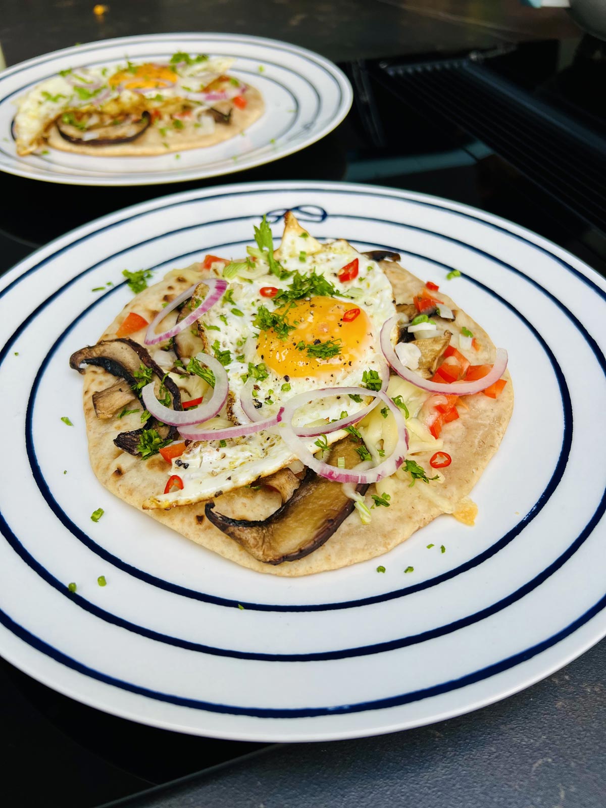 Egg on tortilla ready to be served on a white plate.