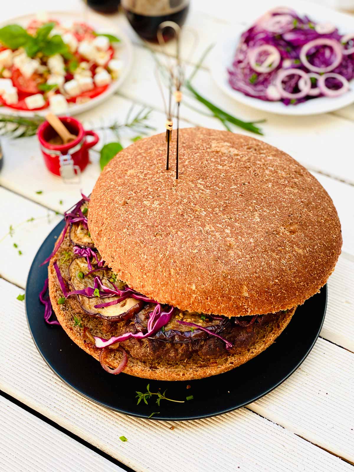 Giant Lamb Burgers on a black plate