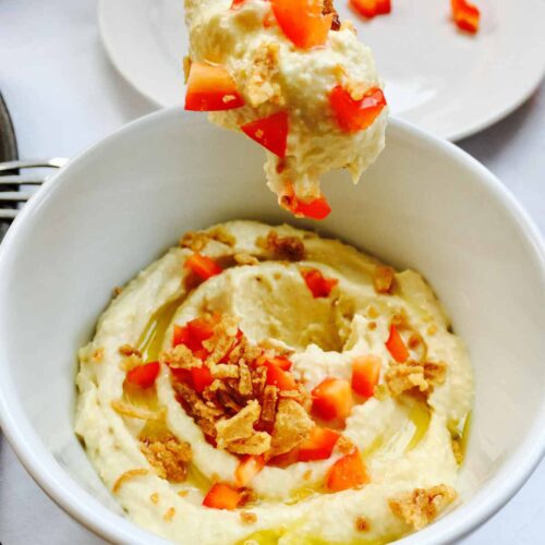 A white bowl of excellent homemade hummus.