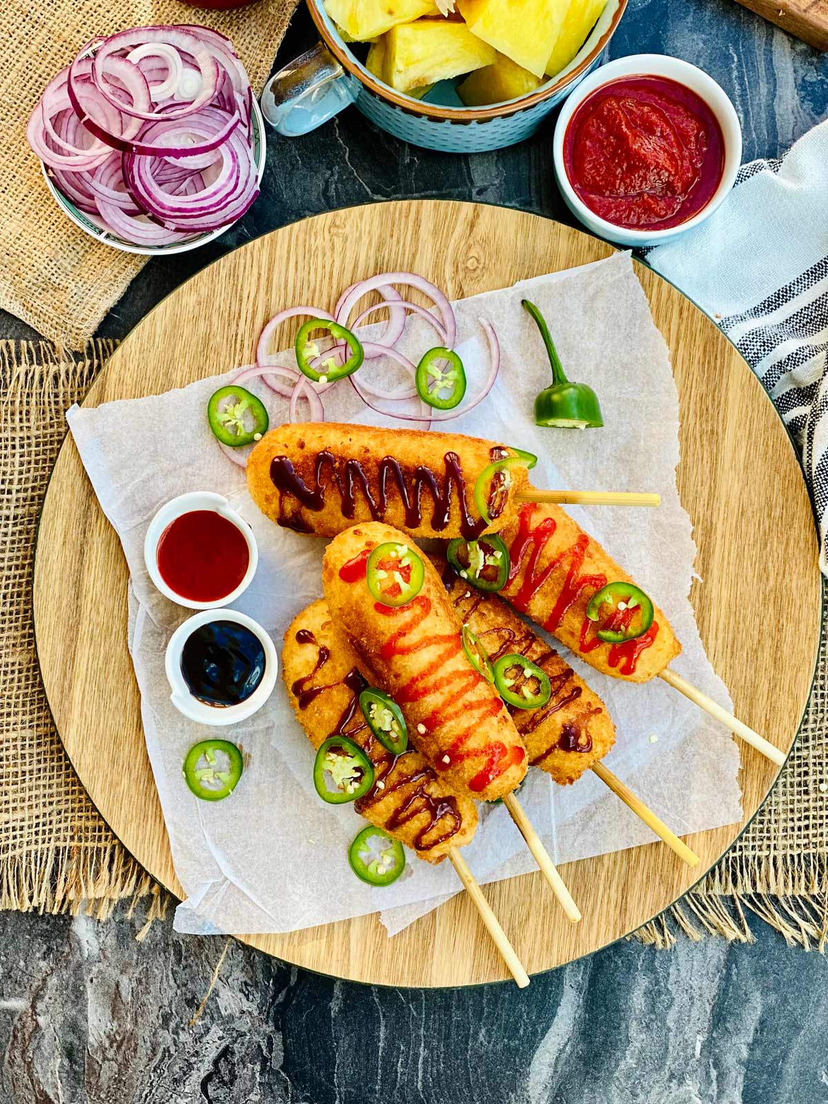 birds eye view of korean corn dogs on a wooden plate