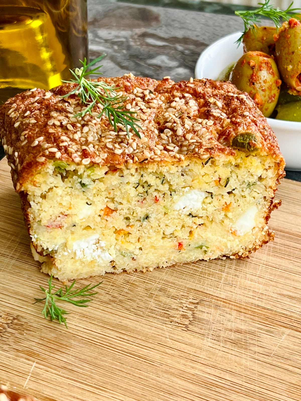 lentil bread close up on a wooden chopping board topped with fresh dill