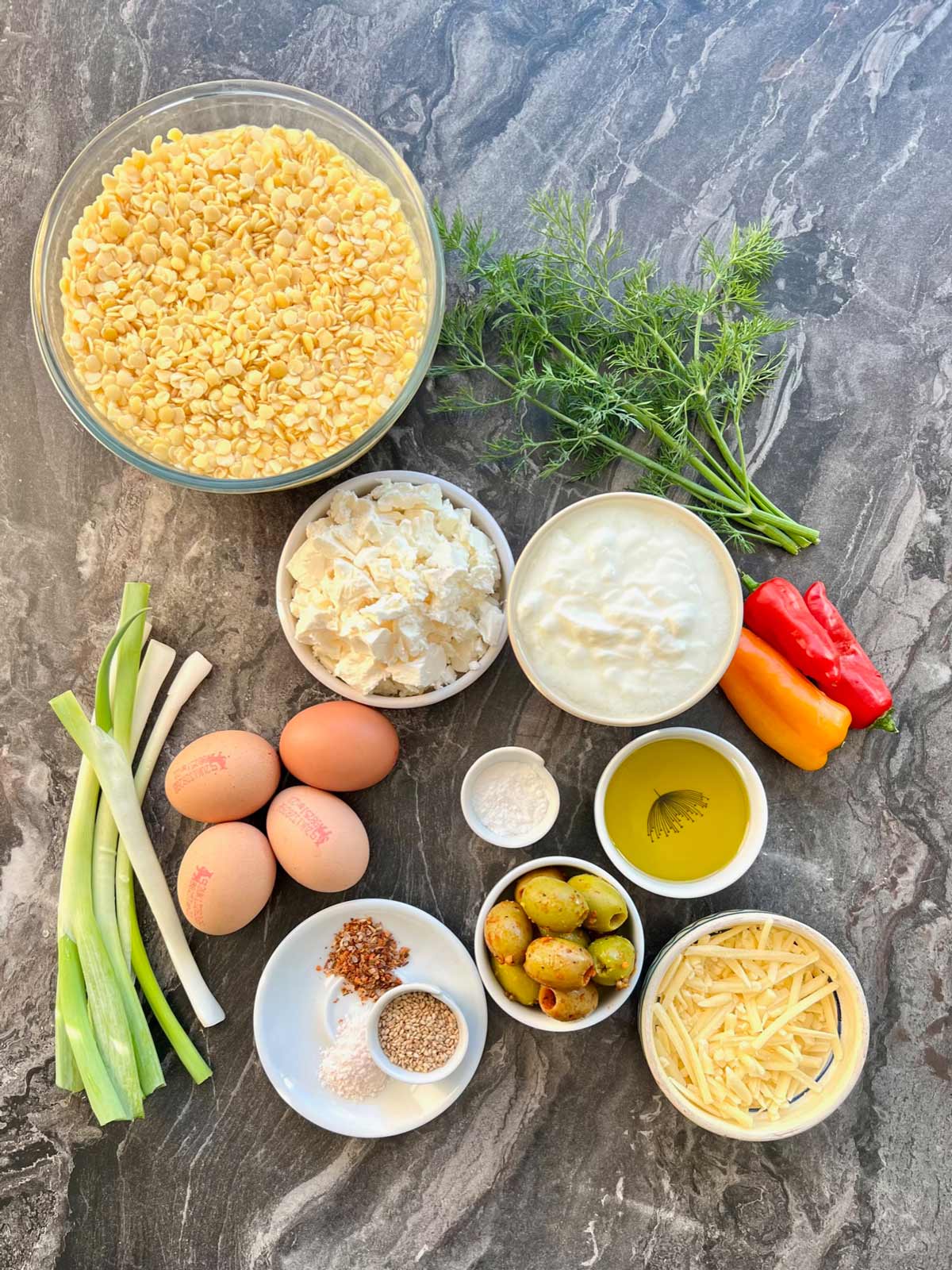 Lentil bread ingredients: Soaked red split lentil, cheese, dill, red peppers, olive oil, Olives, salt, long pepper, scallions/spring onion, eggs, red chilli flakes yogurt and soda bicarbonate