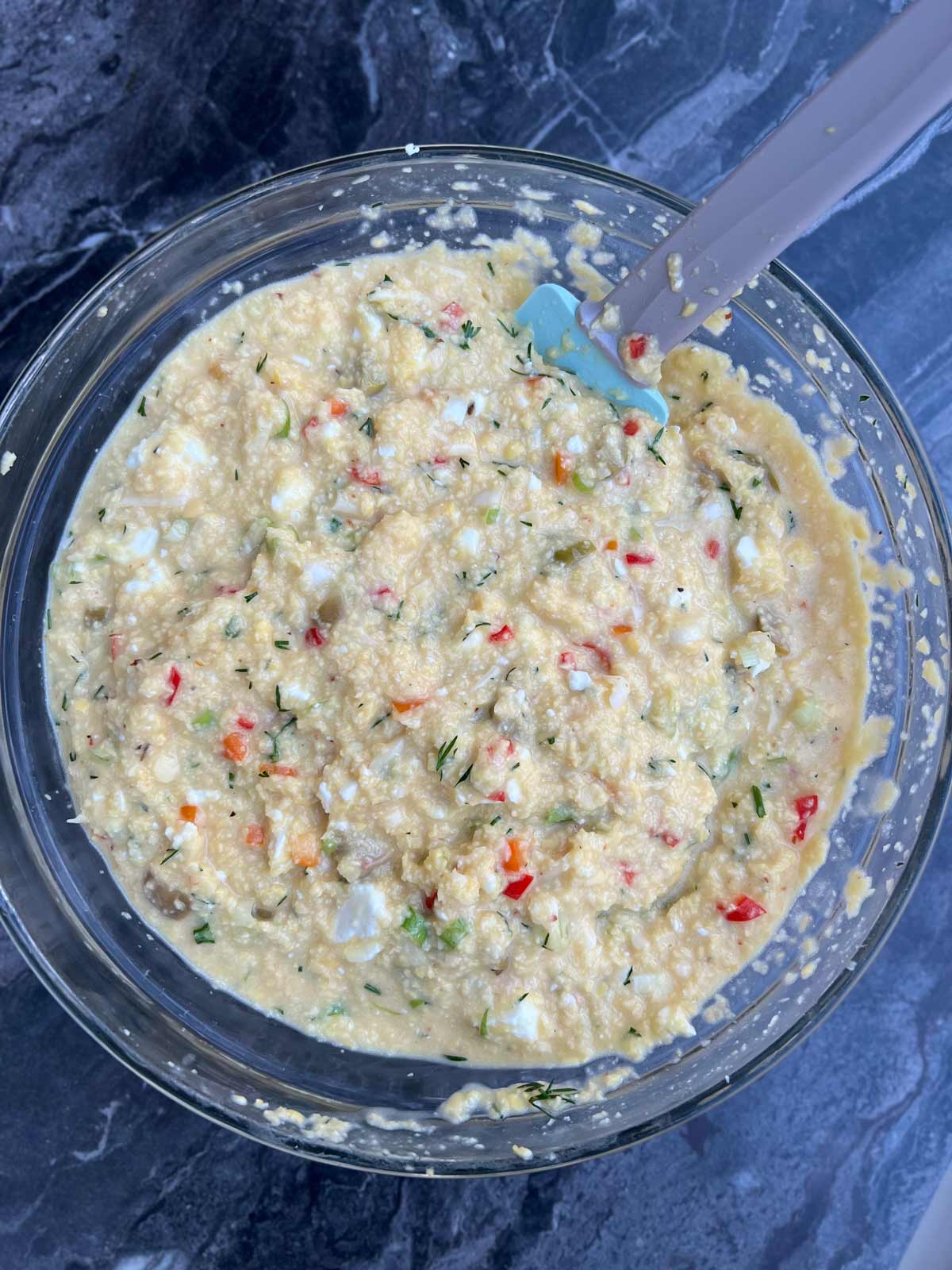 All lentil bread recipe ingredients mixed in a glass bowl ready to be placed in a tin and baked