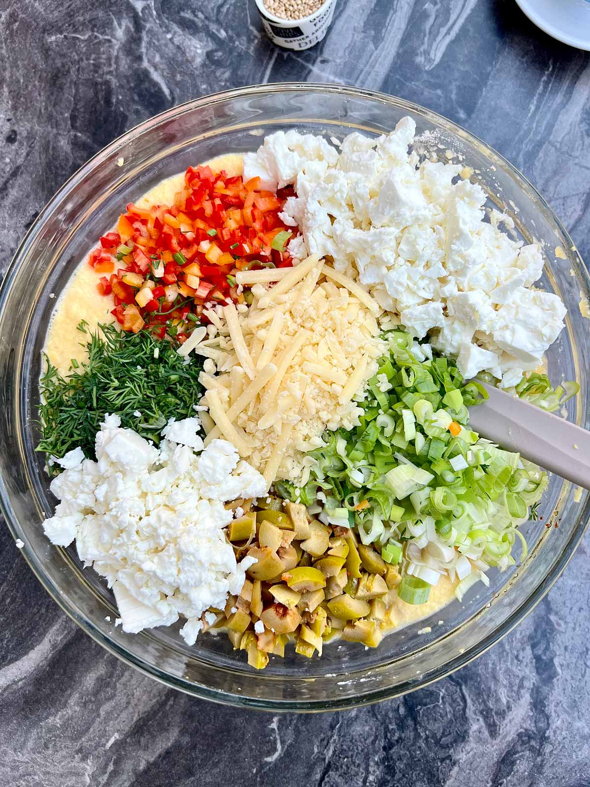 All the ingredients needed for lentil loaf recipe and the cheeses - all added into a glass bowl