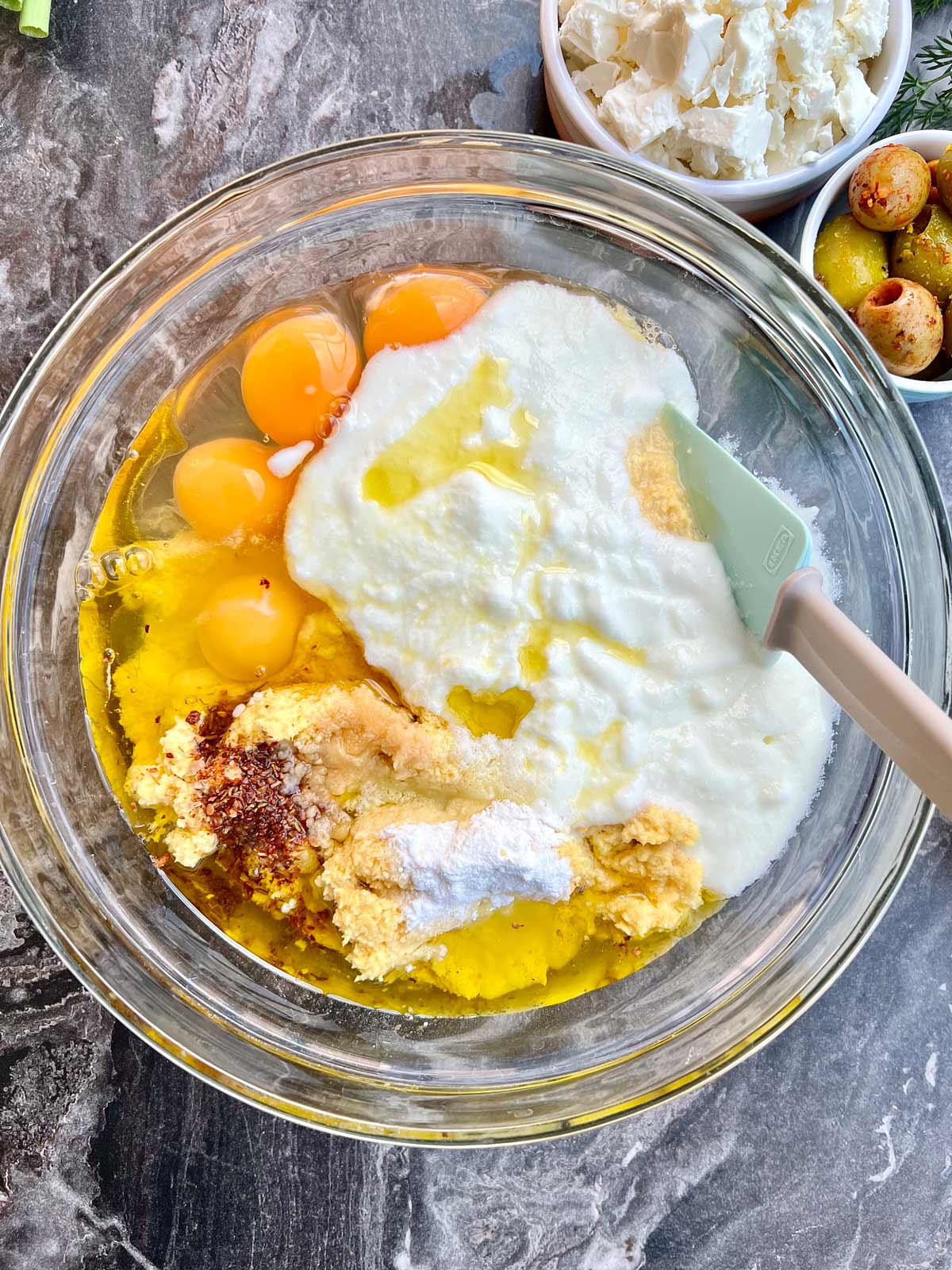 Mixed interments for making the lentil bread in a transparent glass bowl with a spatula in