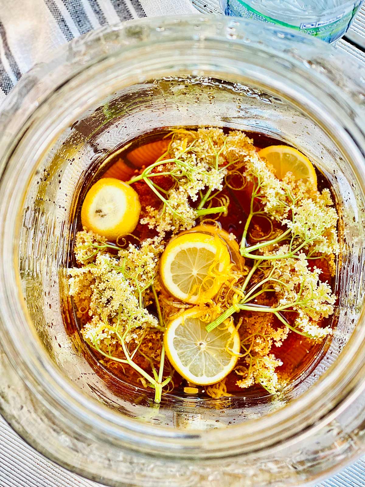 Birds eye shot of elderflower, water sugar lemon slices and lemon rind