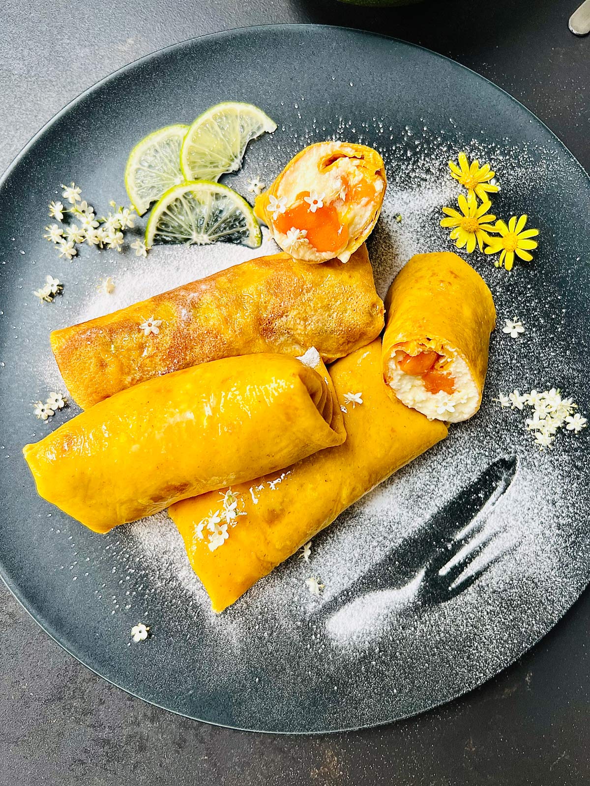 Mango pancakes closeup, dickey arranged and decorated on a serving plate, ready to be tucked into.