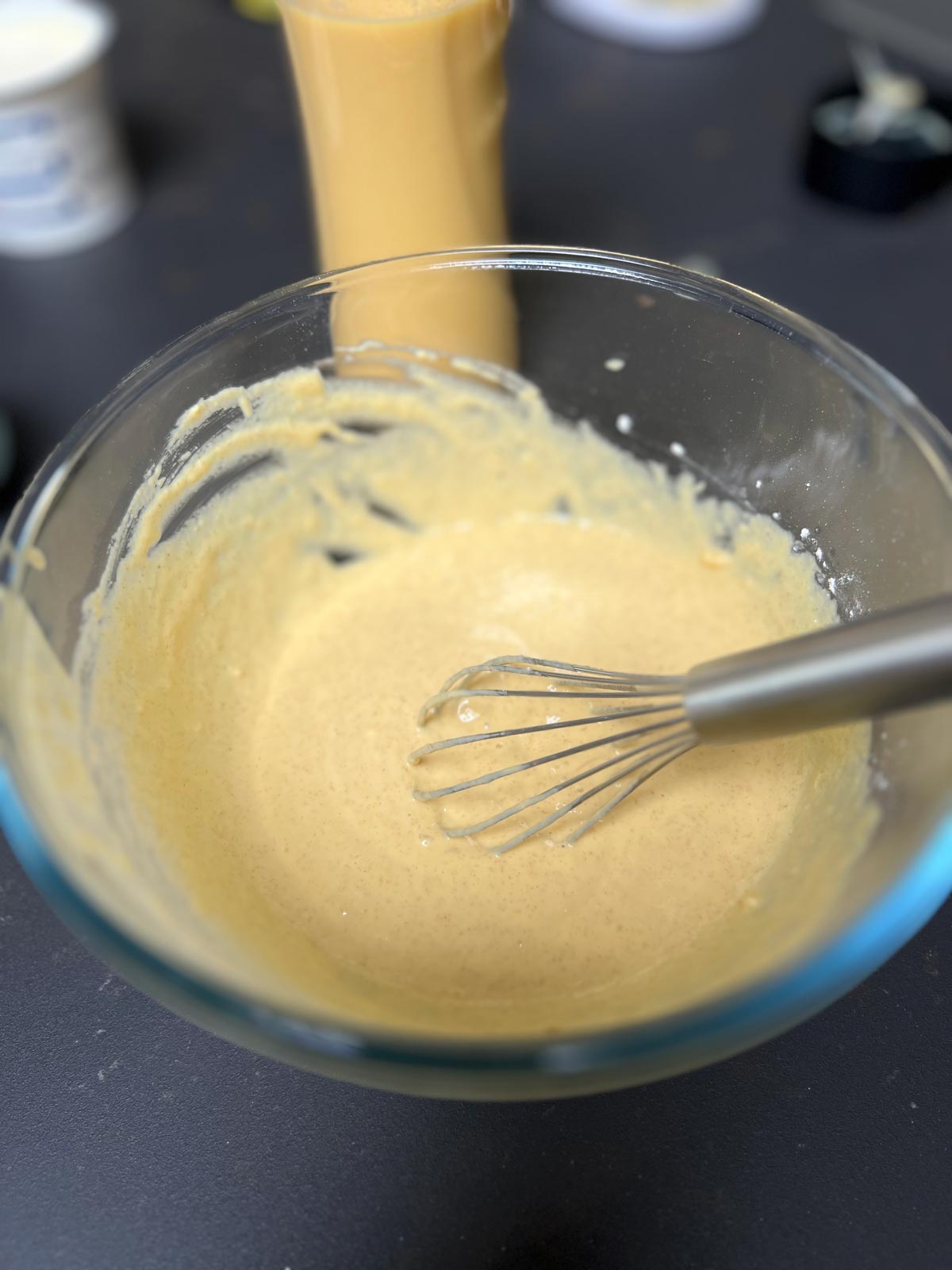 Mixed ingredients for mango pancakes in a bowl.