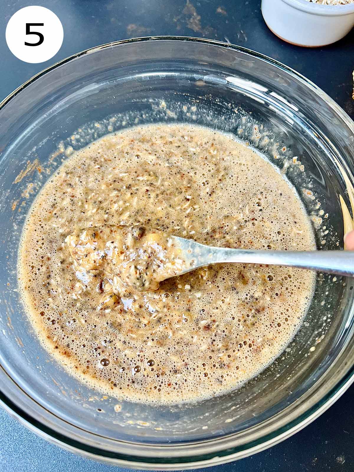 Mixed batter for sugar free banana bread in a glass bowl.