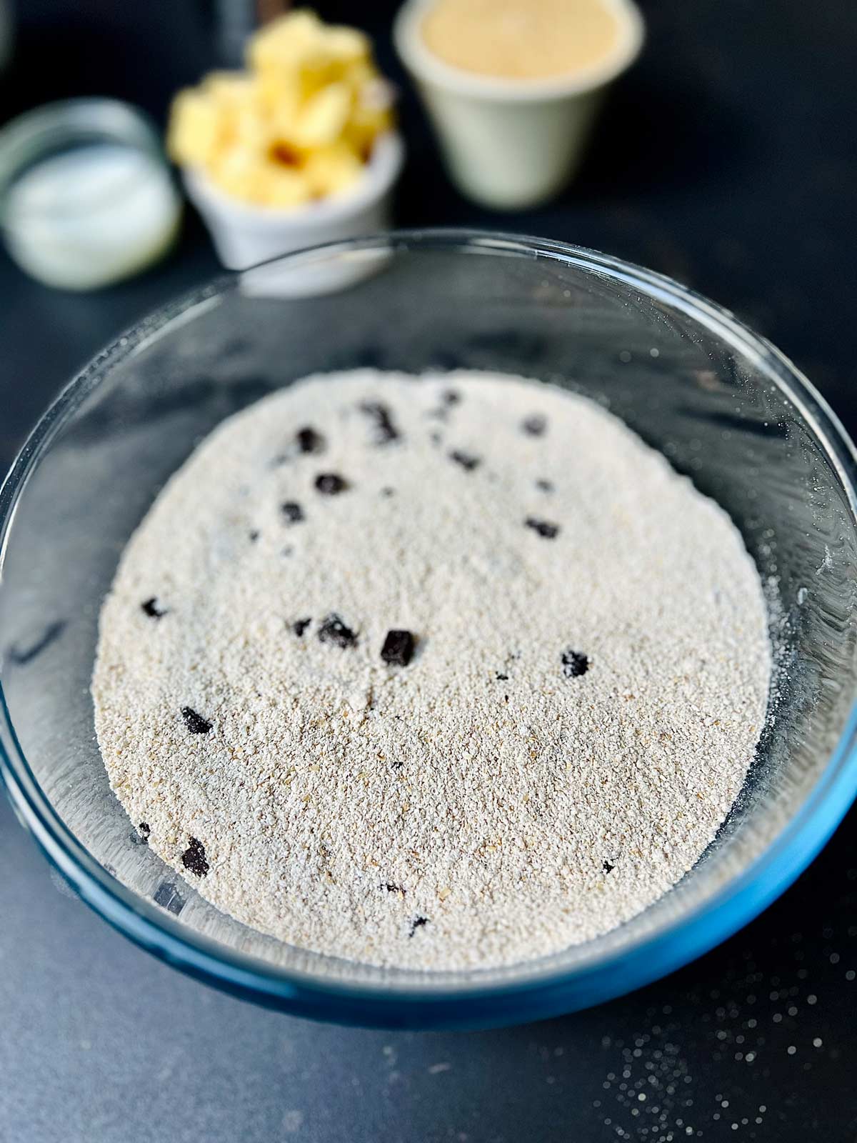 All dry ingredients for oat cookies mixed together into a glass bowl.