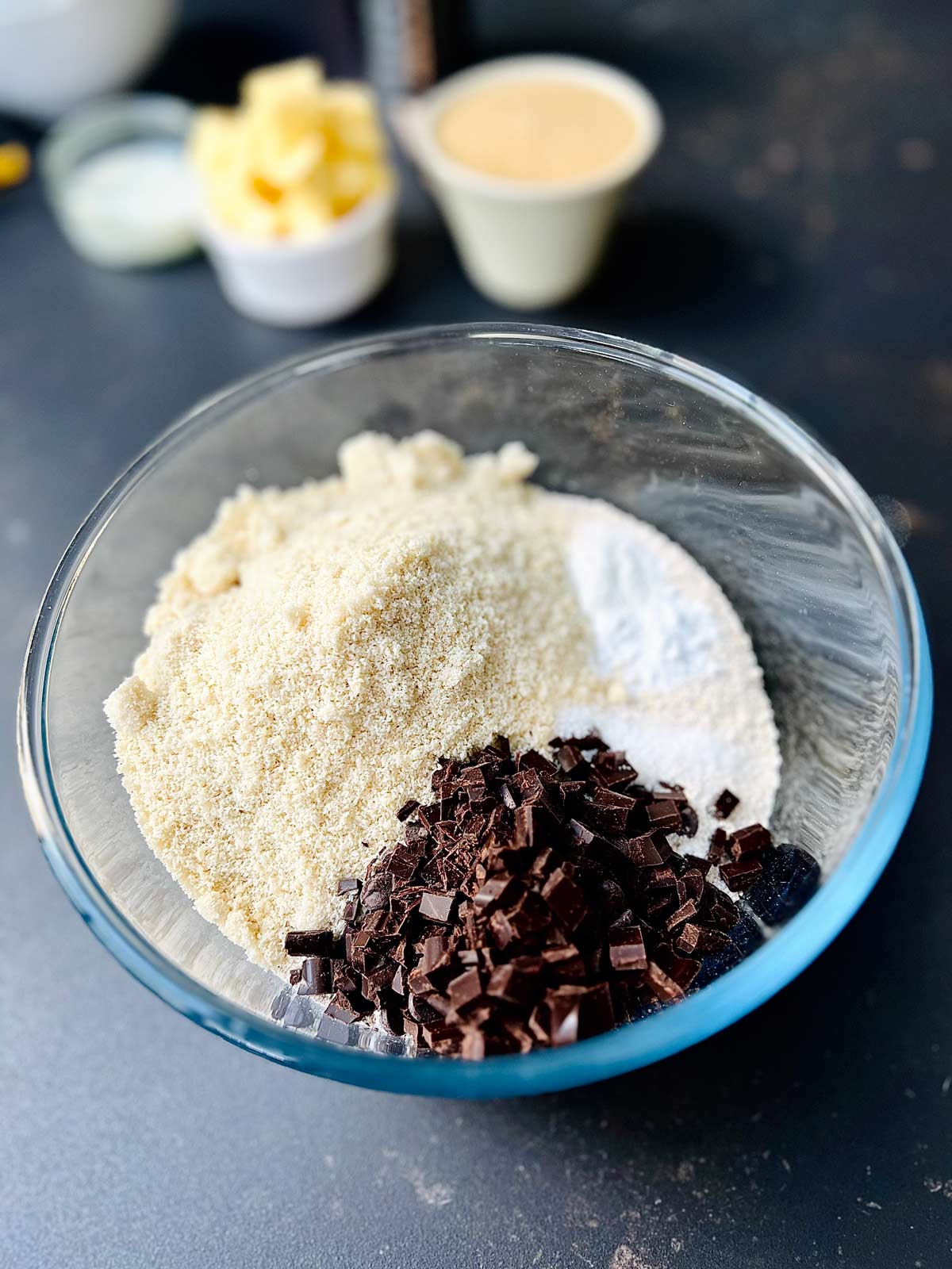 Dry ingredients for oat flour cookies added to a glass bowl.