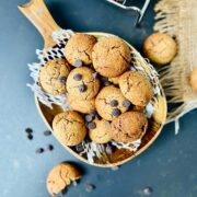 Oat flour cookies in a wooden serving dish sprinkled of chocolate chips.