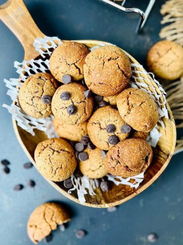 Oat flour cookies in a wooden serving dish sprinkled of chocolate chips.