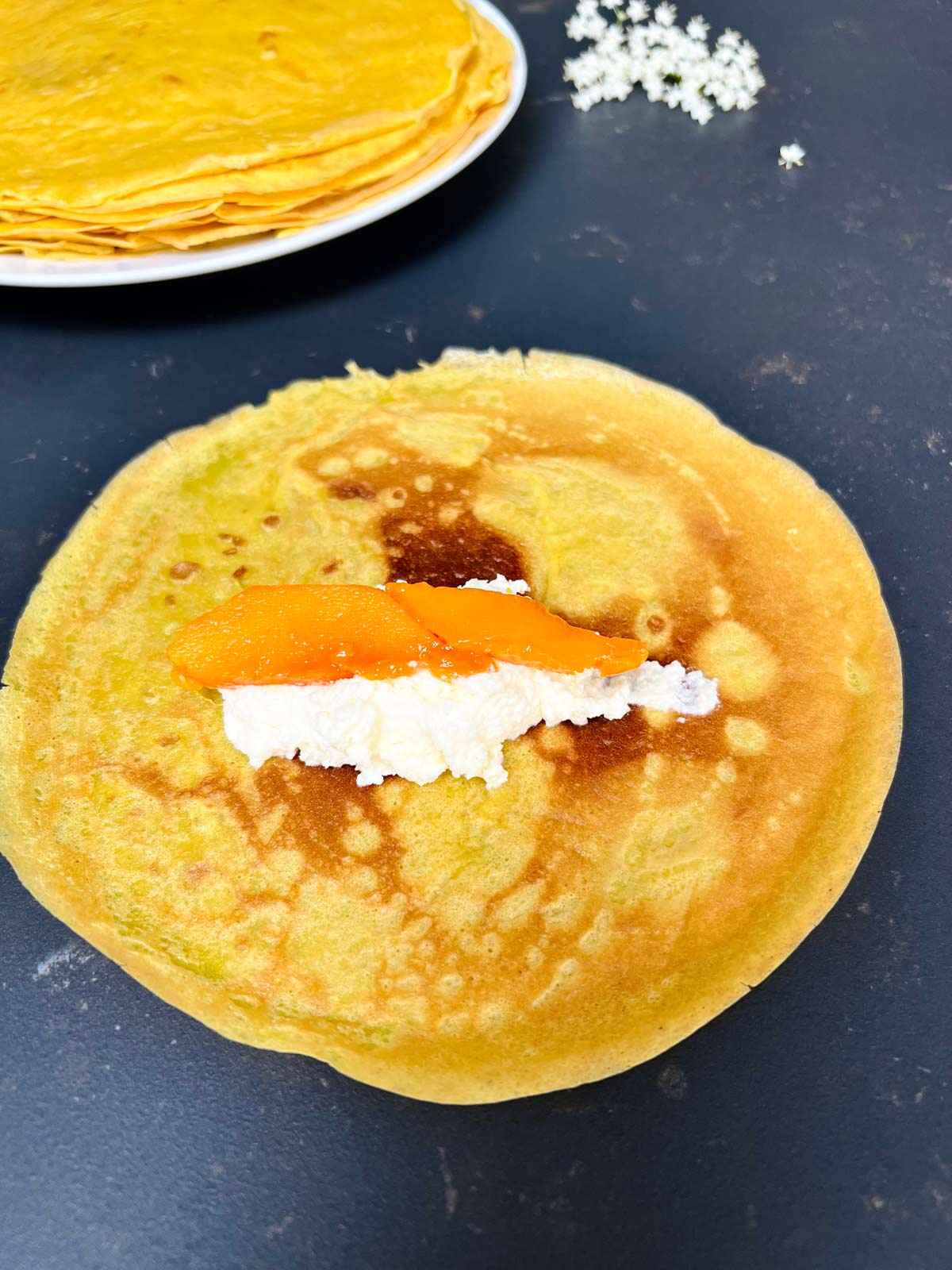 Pancake with filling and two chunks of mango in the centre.