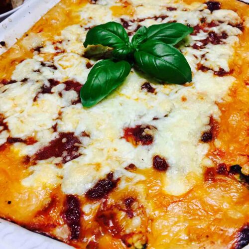 A batch of pasta shells filled with spinach and ricotta cheese, fresh out of the oven.