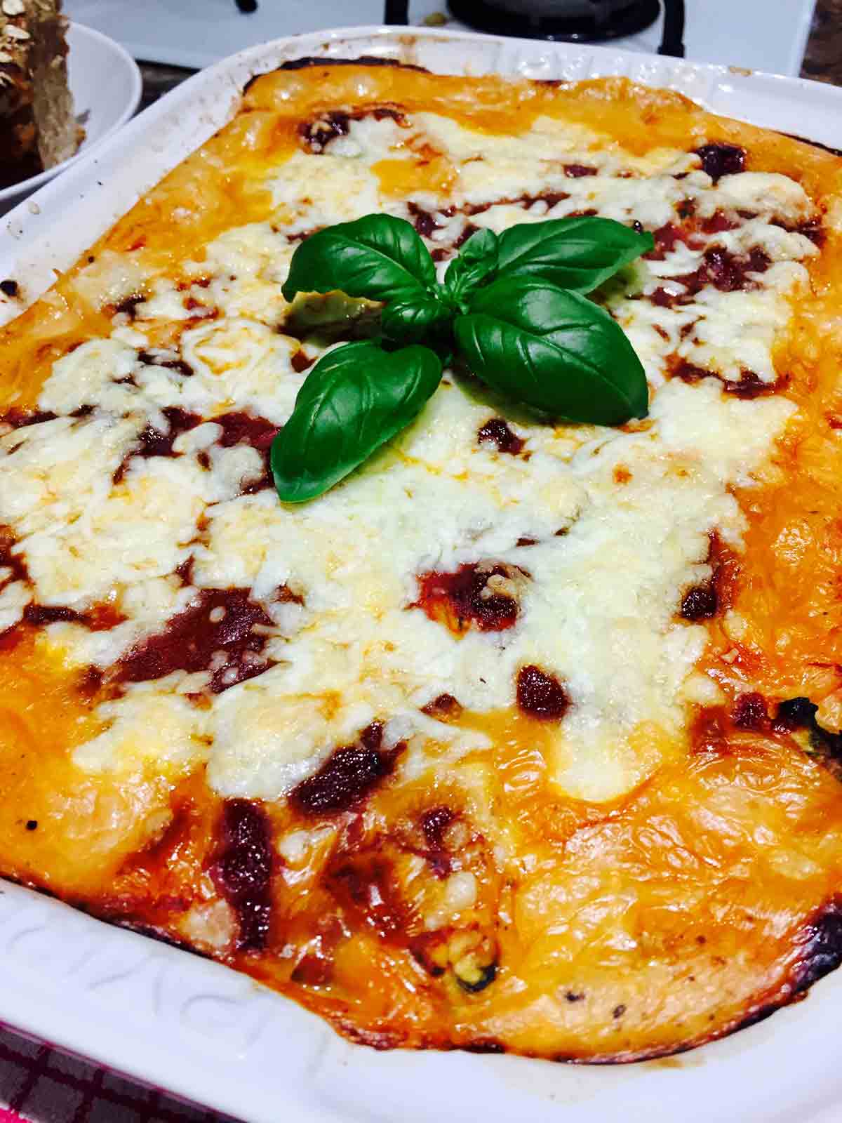 A batch of pasta shells filled with spinach and ricotta cheese, fresh out of the oven.