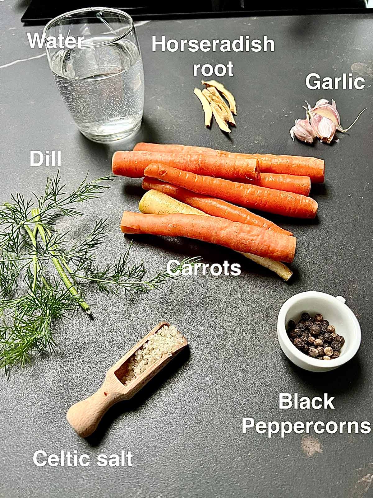 Ingredients needed for pickling carrots: horseradish, carrots, garlic, water, Peppercorns and Celtic salt.