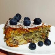 A slice of pineapple, berries & coconut cake