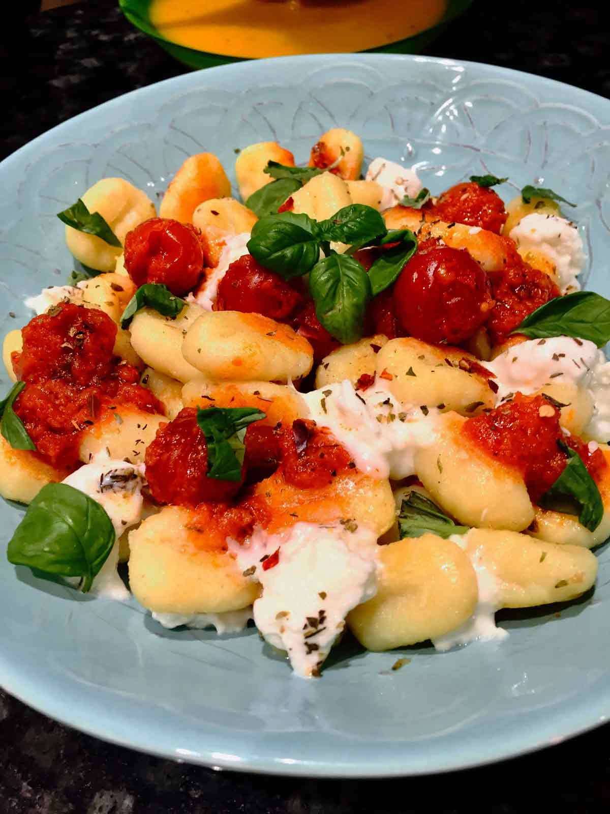 Serve potato gnocchi with buffalo mozzarella and whole cherry tomatoes and basil sauce, an absolutely yummy pasta dish.